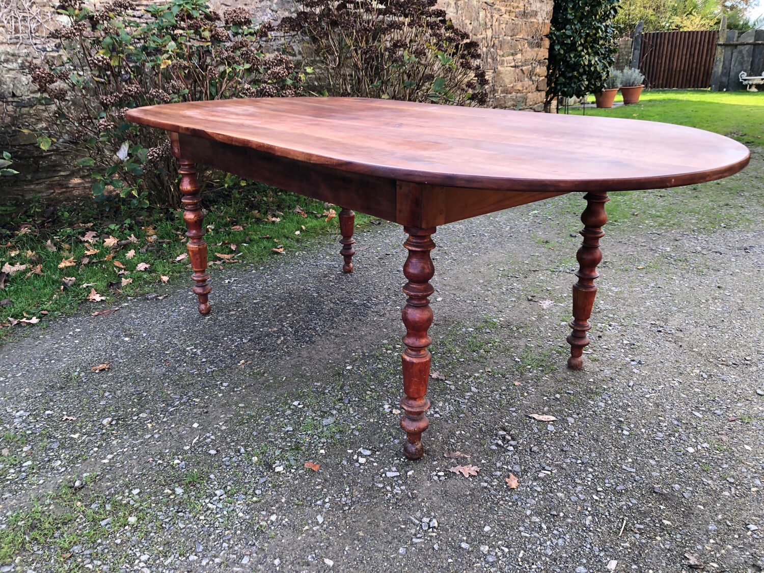 Antique cherry wood farmhouse table with rounded ends