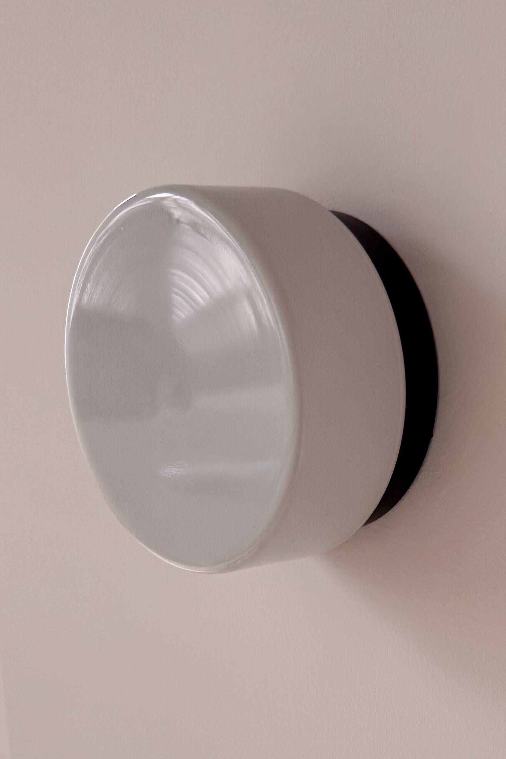 Vintage wall light in black Bakelite and opaline, France 1970.