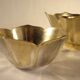 Two brass trundle cups