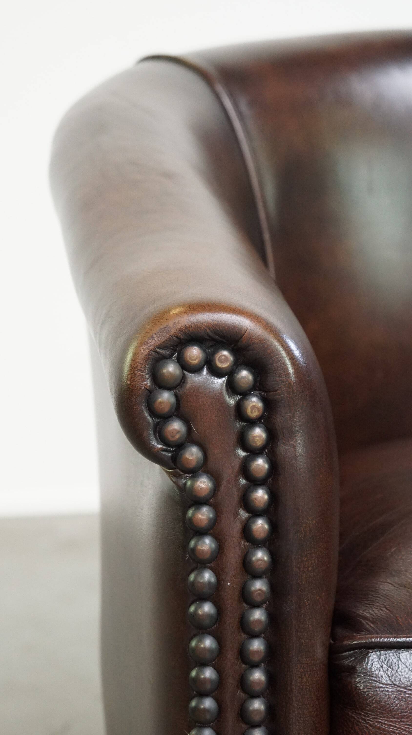 luxury dark leather club chair with English-style ball feet