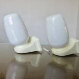 Pair of "streamline" opaline wall lights, France, 1970s-1980s.