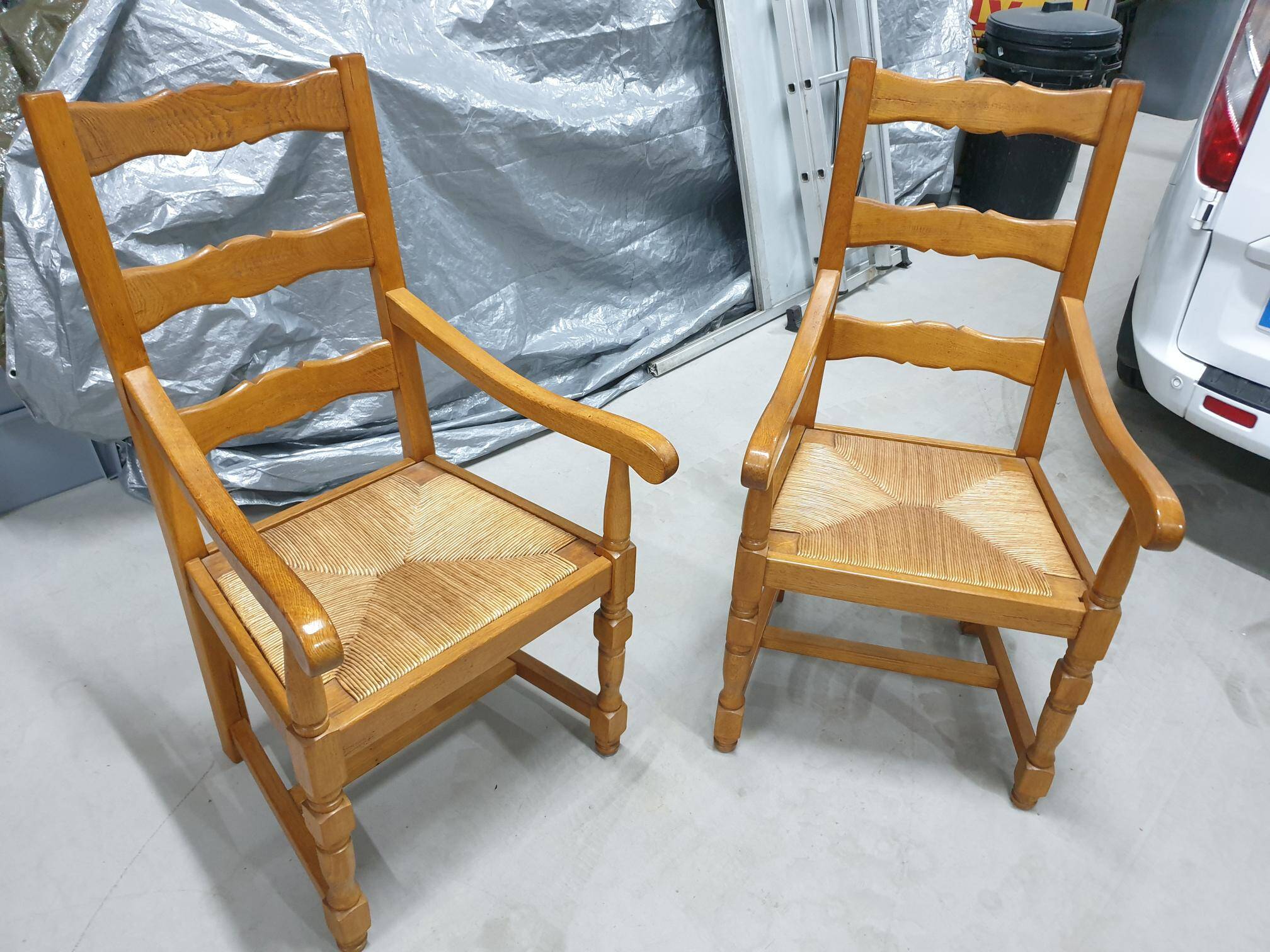 Two oak armchairs with straw seats