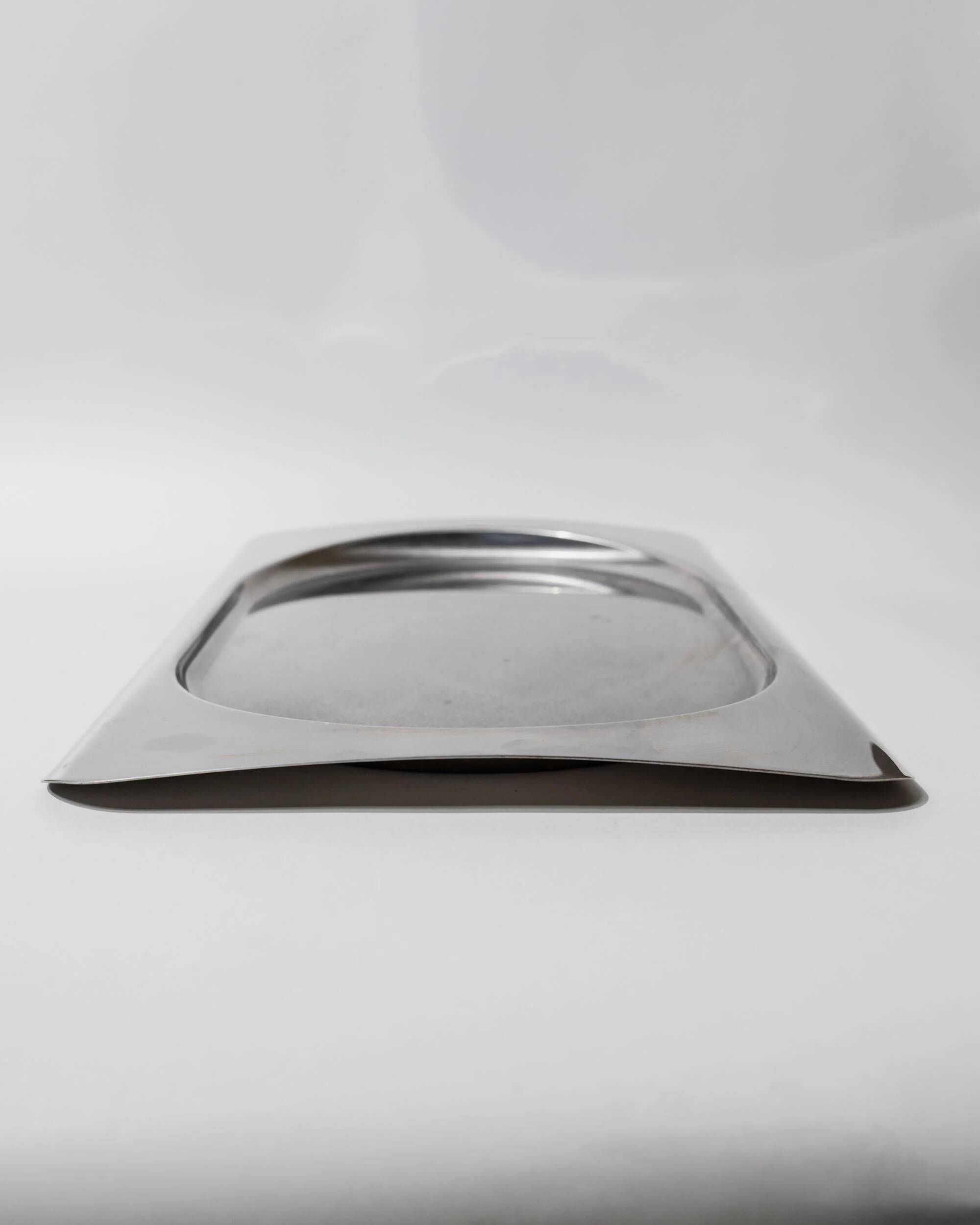 1990s vintage stainless steel platter, rectangular with an oval indentation, minimalist modern design.