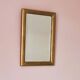 Petit miroir ancien en bois doré et glace biseautée