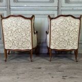 Pair of small Louis XV style wing chairs in carved walnut, Bosson stamp