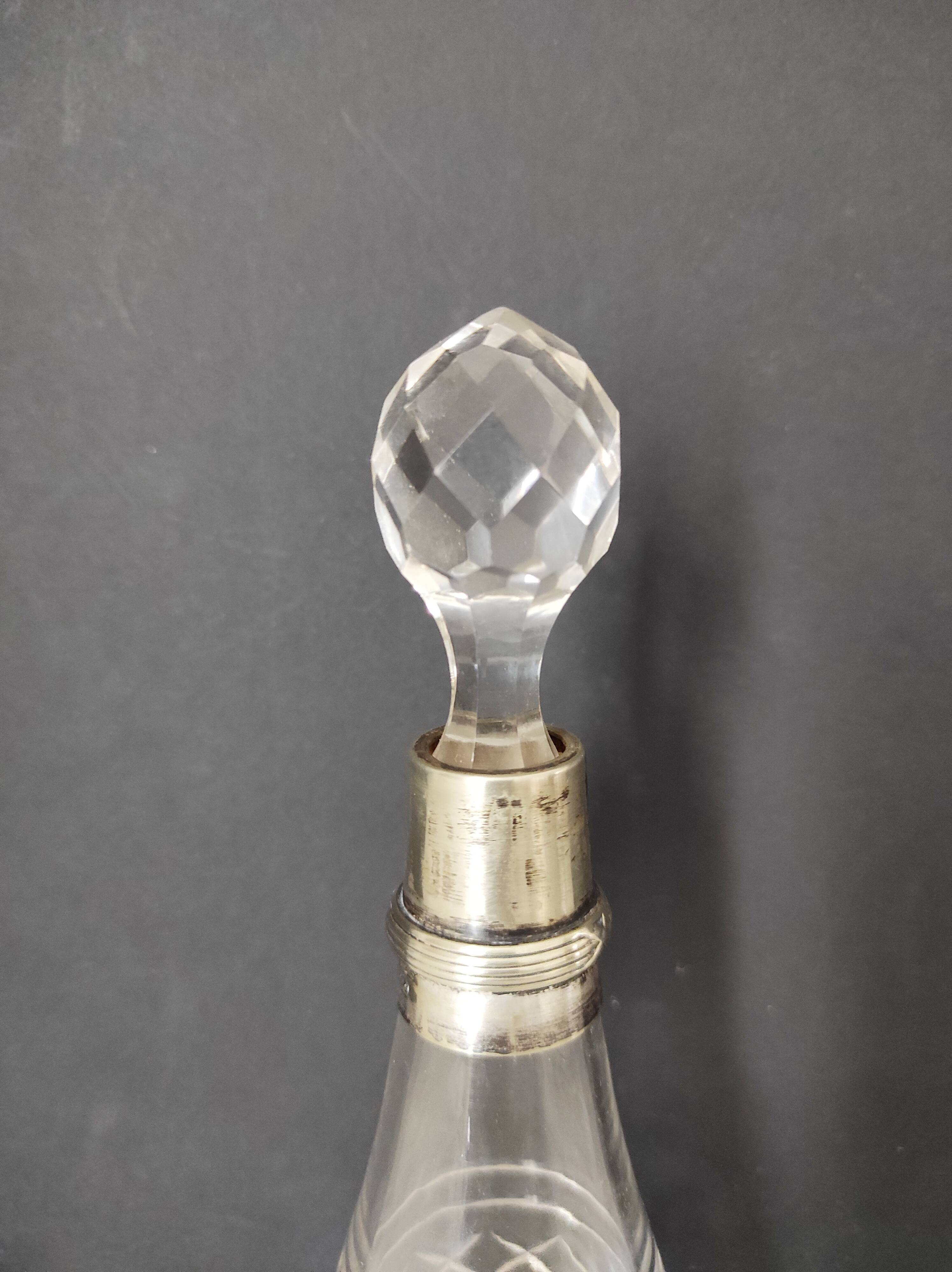 Crystal bottle with silver metal neck rim