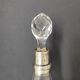 Crystal bottle with silver metal neck rim