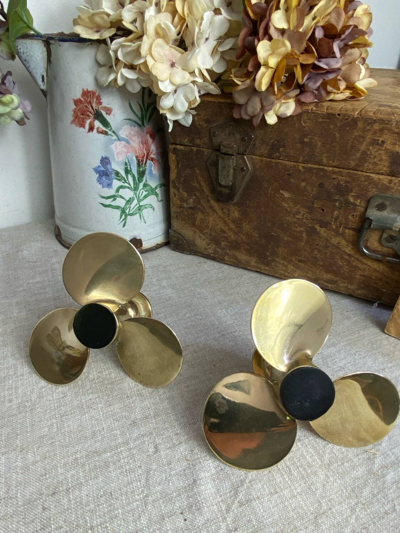 Pair of vintage brass propeller-shaped candlesticks