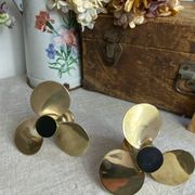 Pair of vintage brass propeller-shaped candlesticks