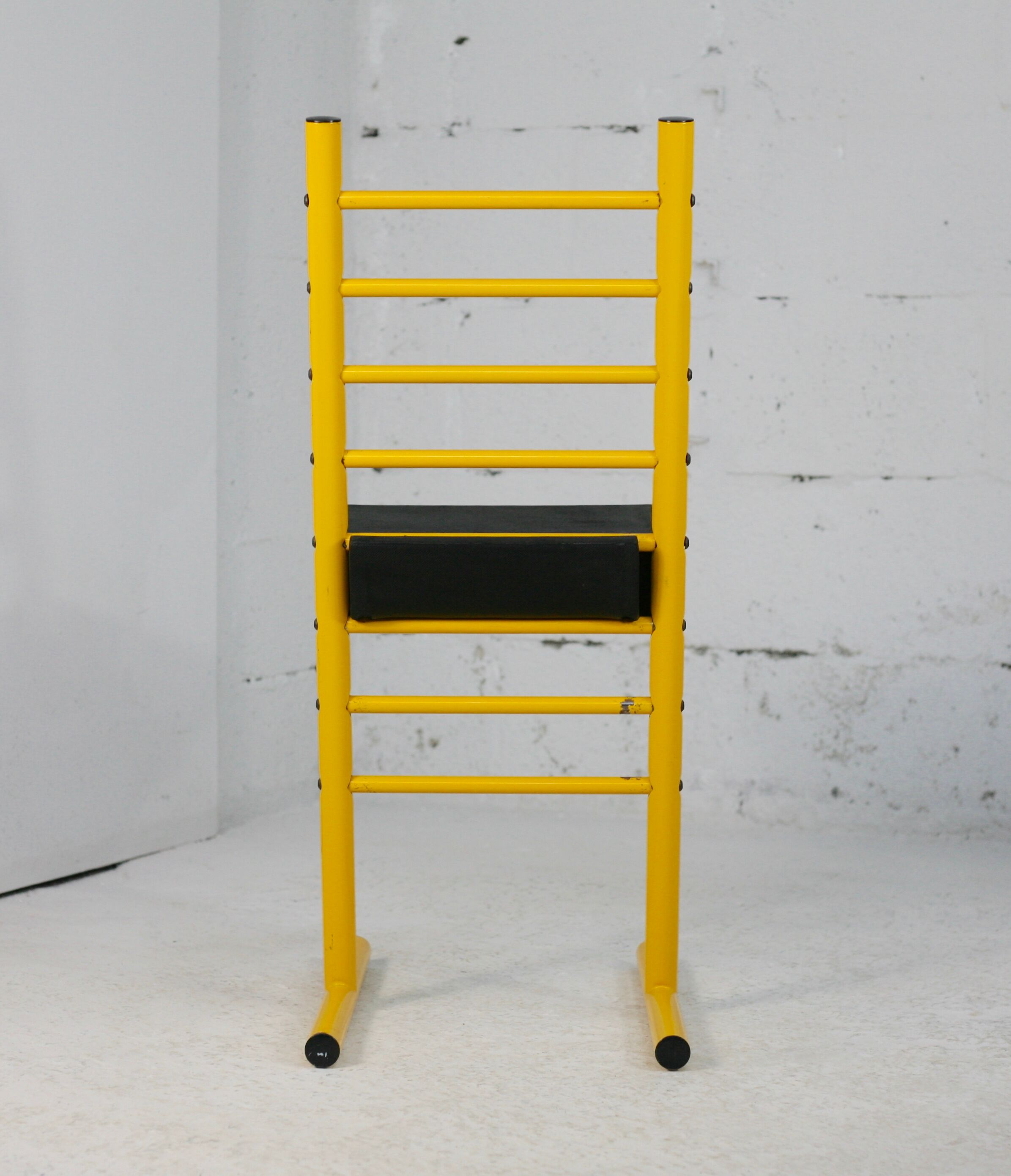 Adjustable seat chair. Circa 1980. Italy. Yellow lacquered steel.
