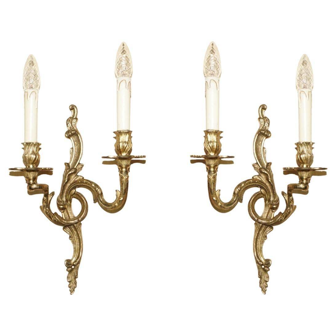 Pair of antique wall sconces from the 1920s in gilded bronze.