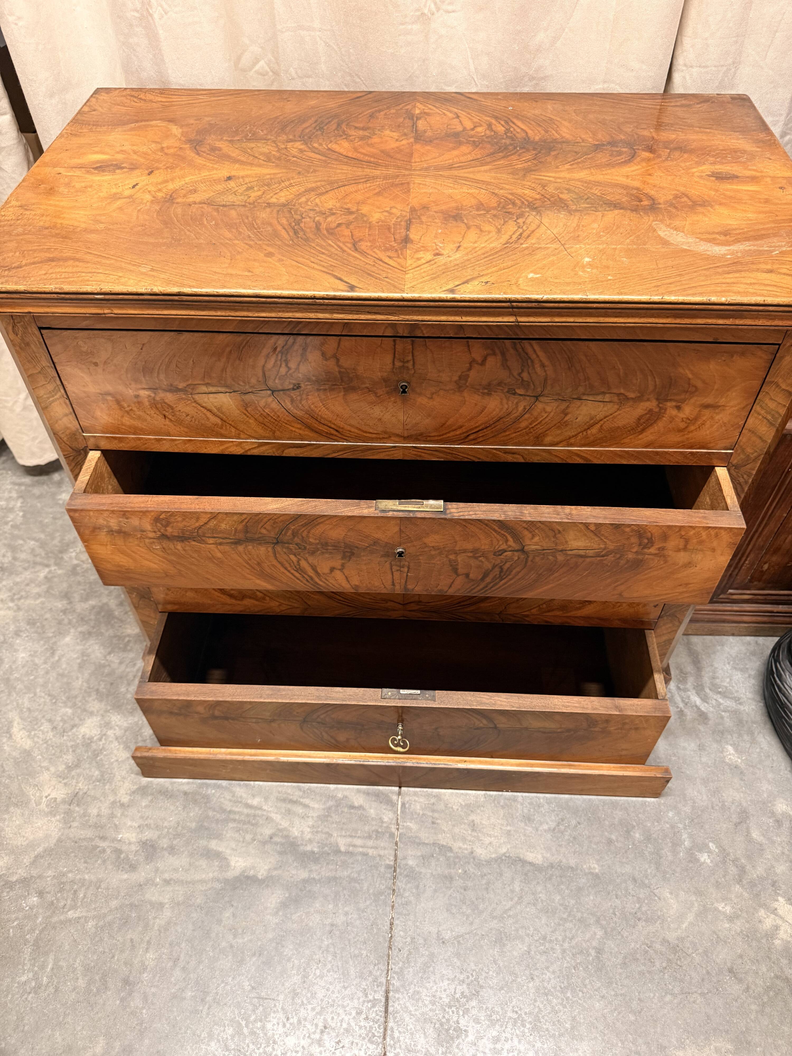 Antique English commode in flame walnut.