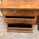 Antique English commode in flame walnut.