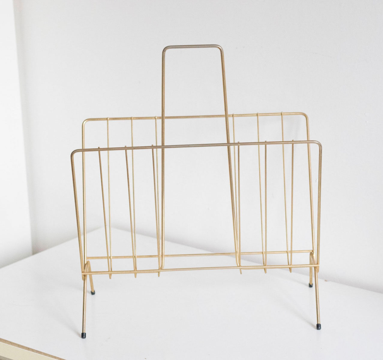 Vintage magazine holder in gold metal