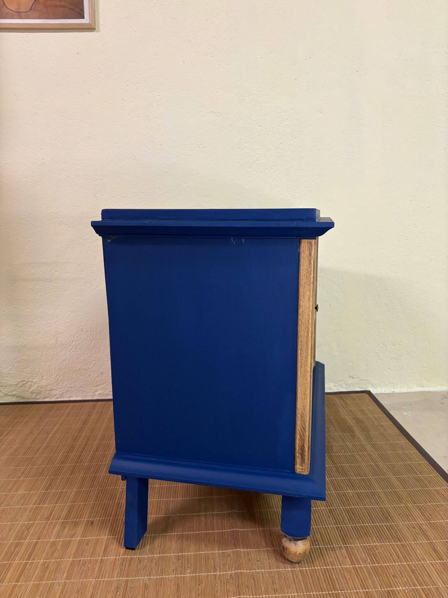 Small vintage upcycled side table in midnight blue and raw wood, with a rose-shaped door.