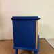 Small vintage upcycled side table in midnight blue and raw wood, with a rose-shaped door.