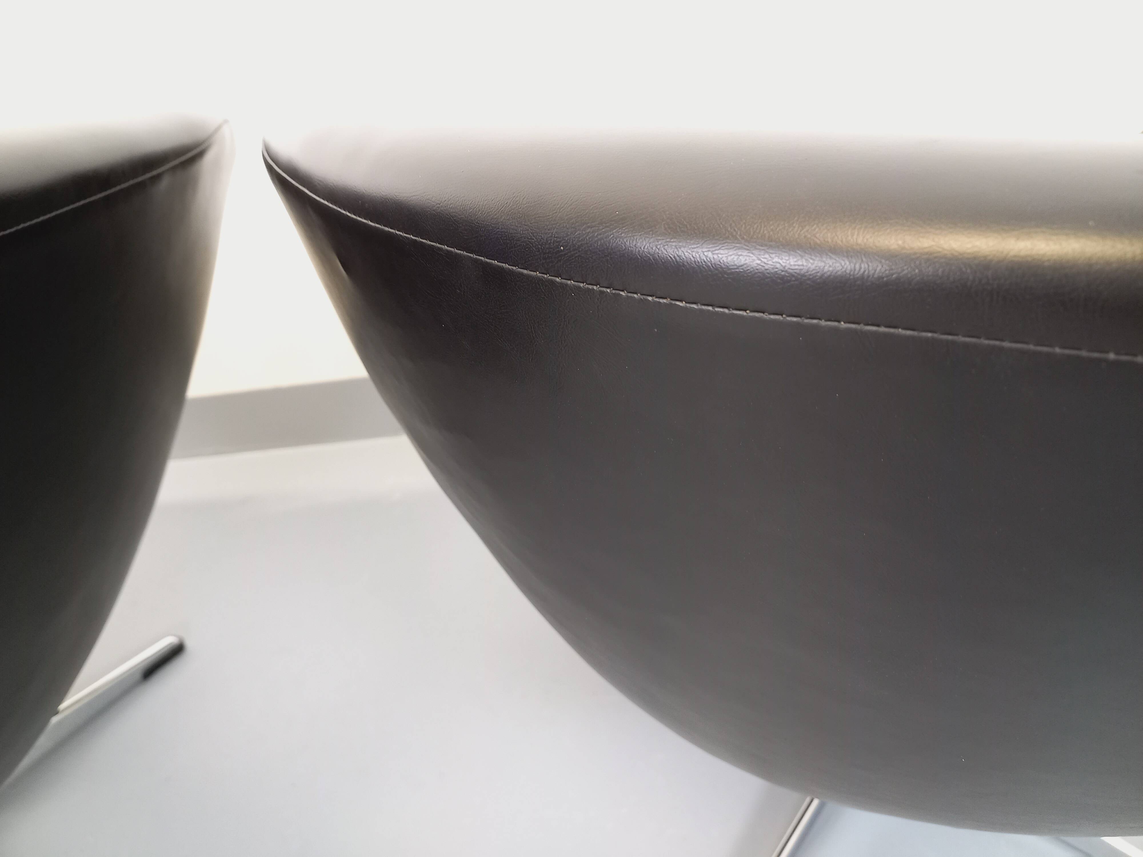 Pair of vintage Scandinavian swivel armchairs in faux leather and chrome.