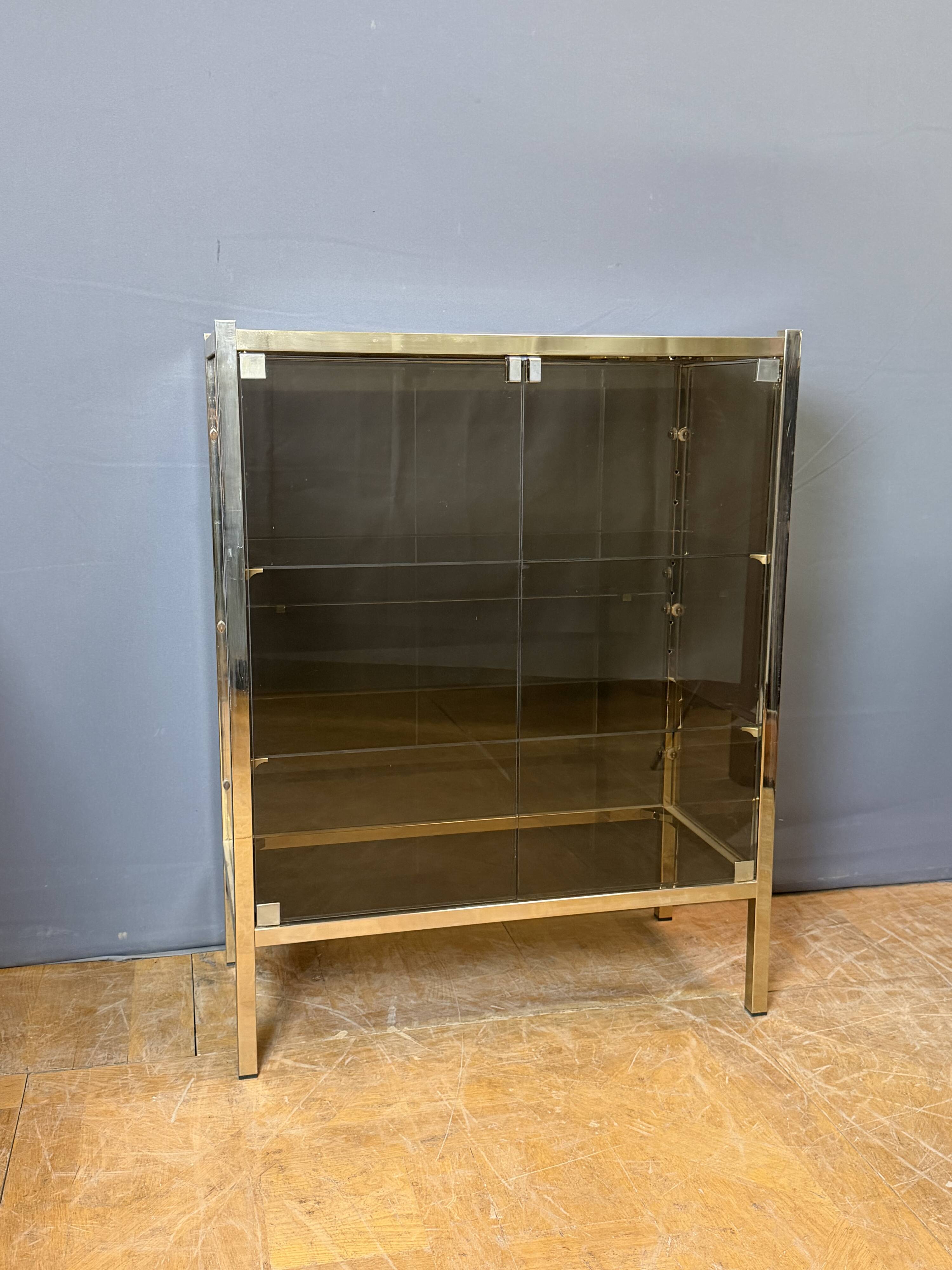 Chrome-plated brass display cabinet with smoked glass.