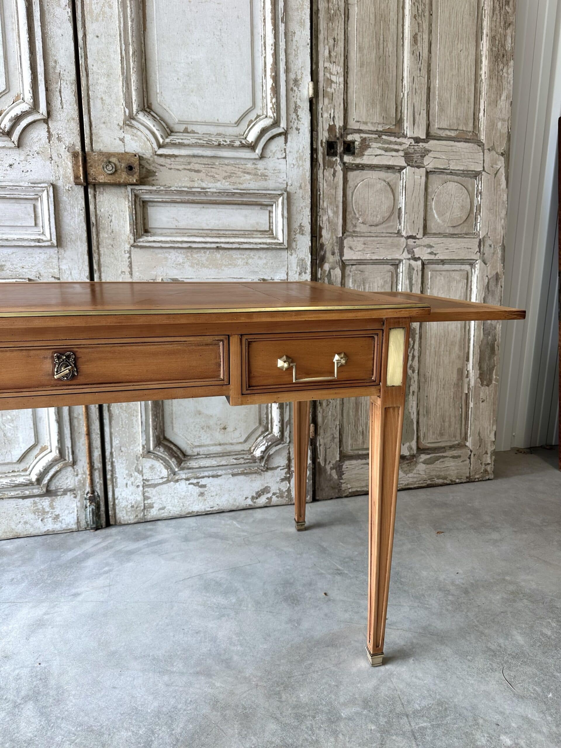 Directoire style flat desk circa 1960 in light cherry wood.