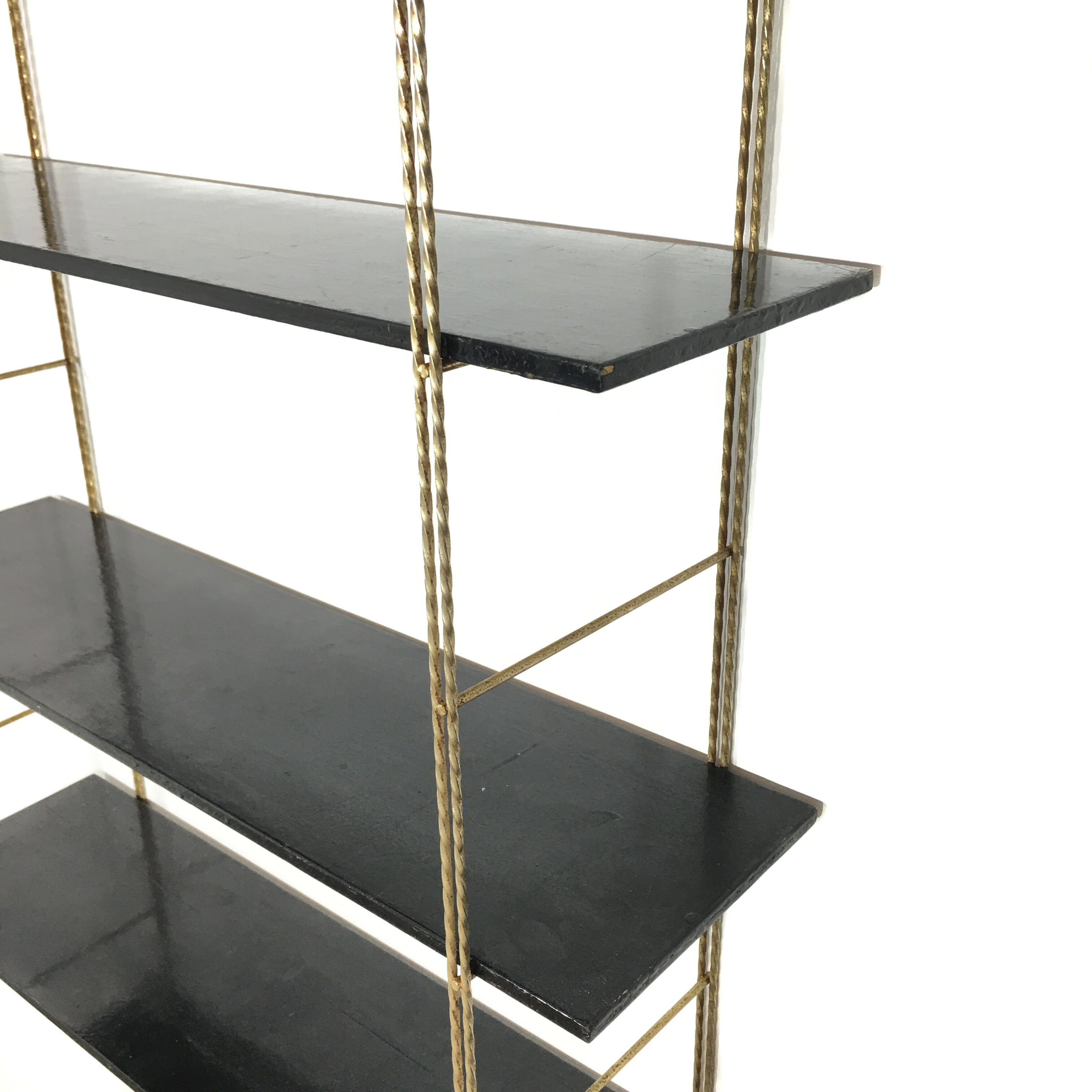String gold metal shelf and black wood