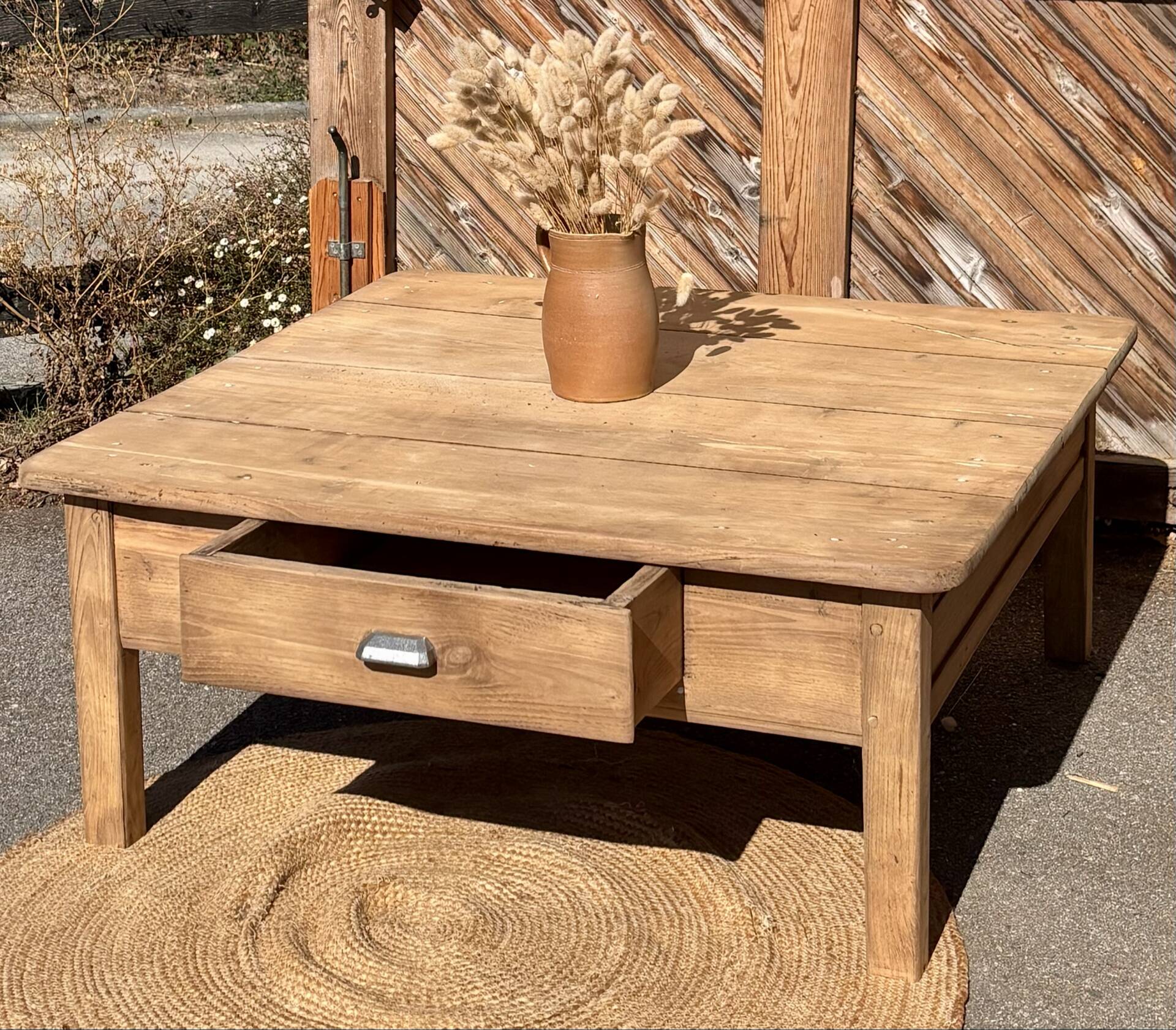 Large square farmhouse coffee table made of raw solid oak.