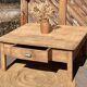 Large square farmhouse coffee table made of raw solid oak.