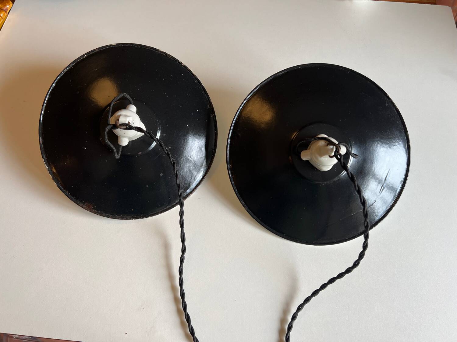 Pair of black and white sheet metal pendant lights, ceramic sockets