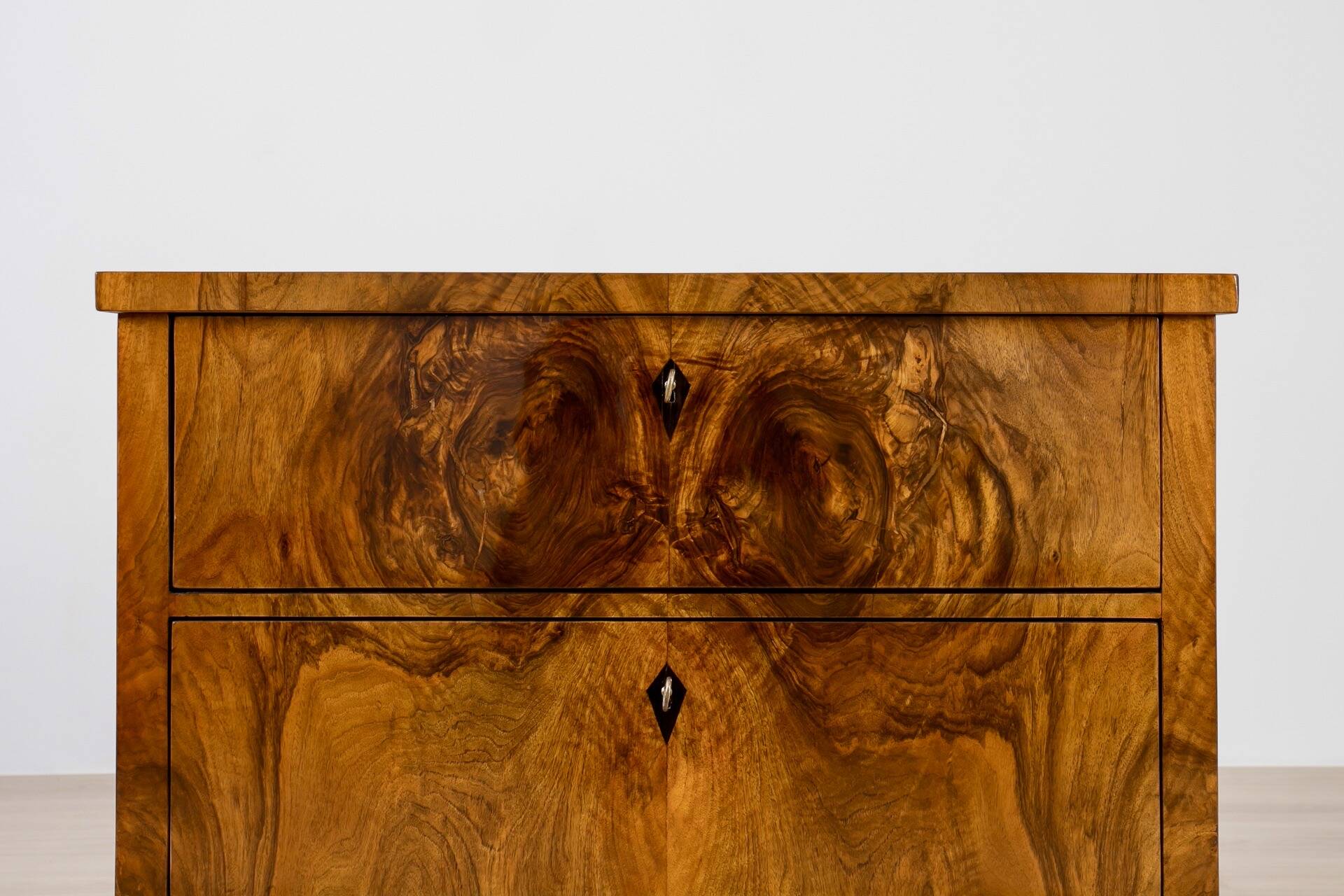 Elegant pair of Biedermeier style walnut commodes, Germany, French polish.