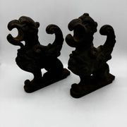 Pair of winged chimera and dragon fire dogs in cast iron