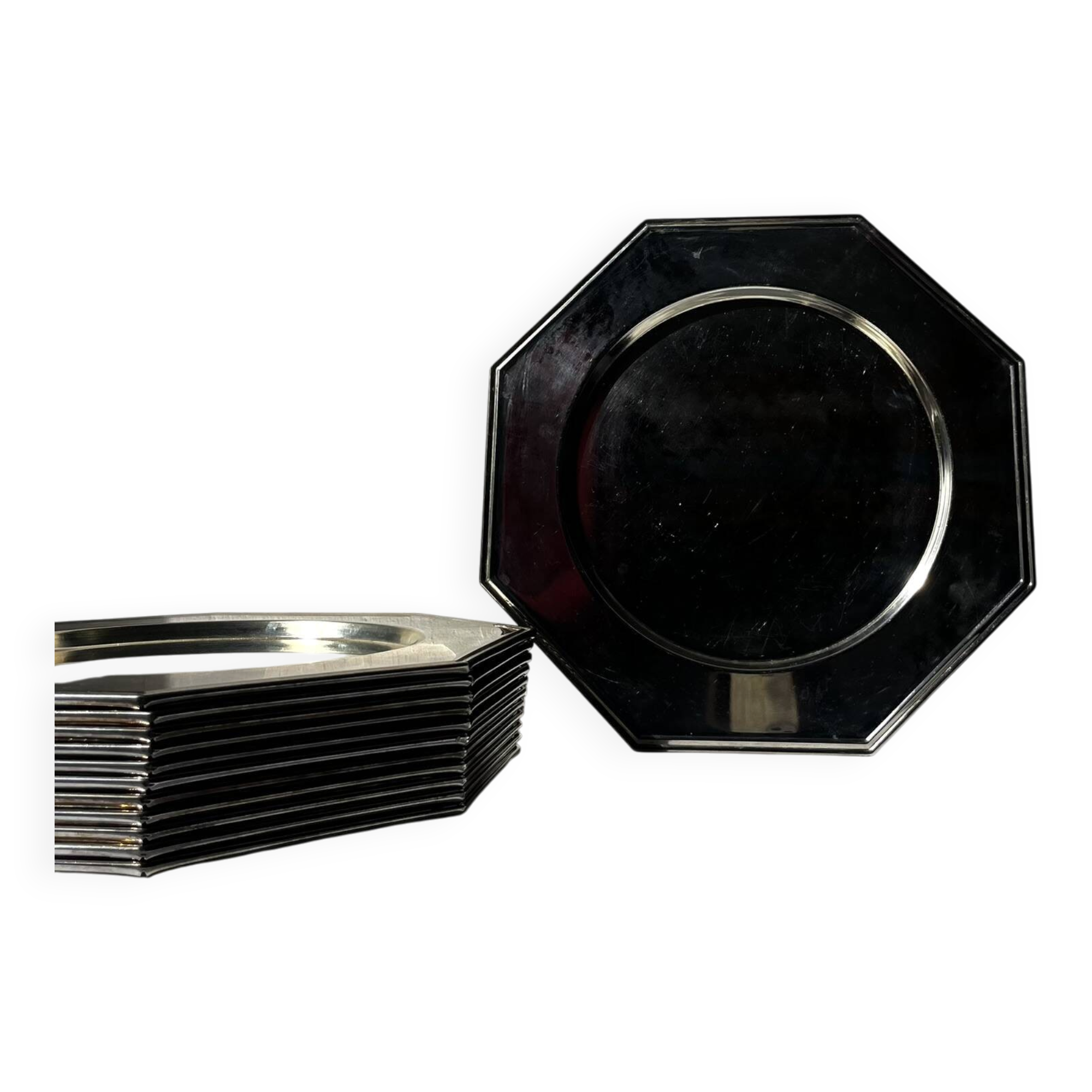 Many octagonal presentation plates in silver-plated metal.