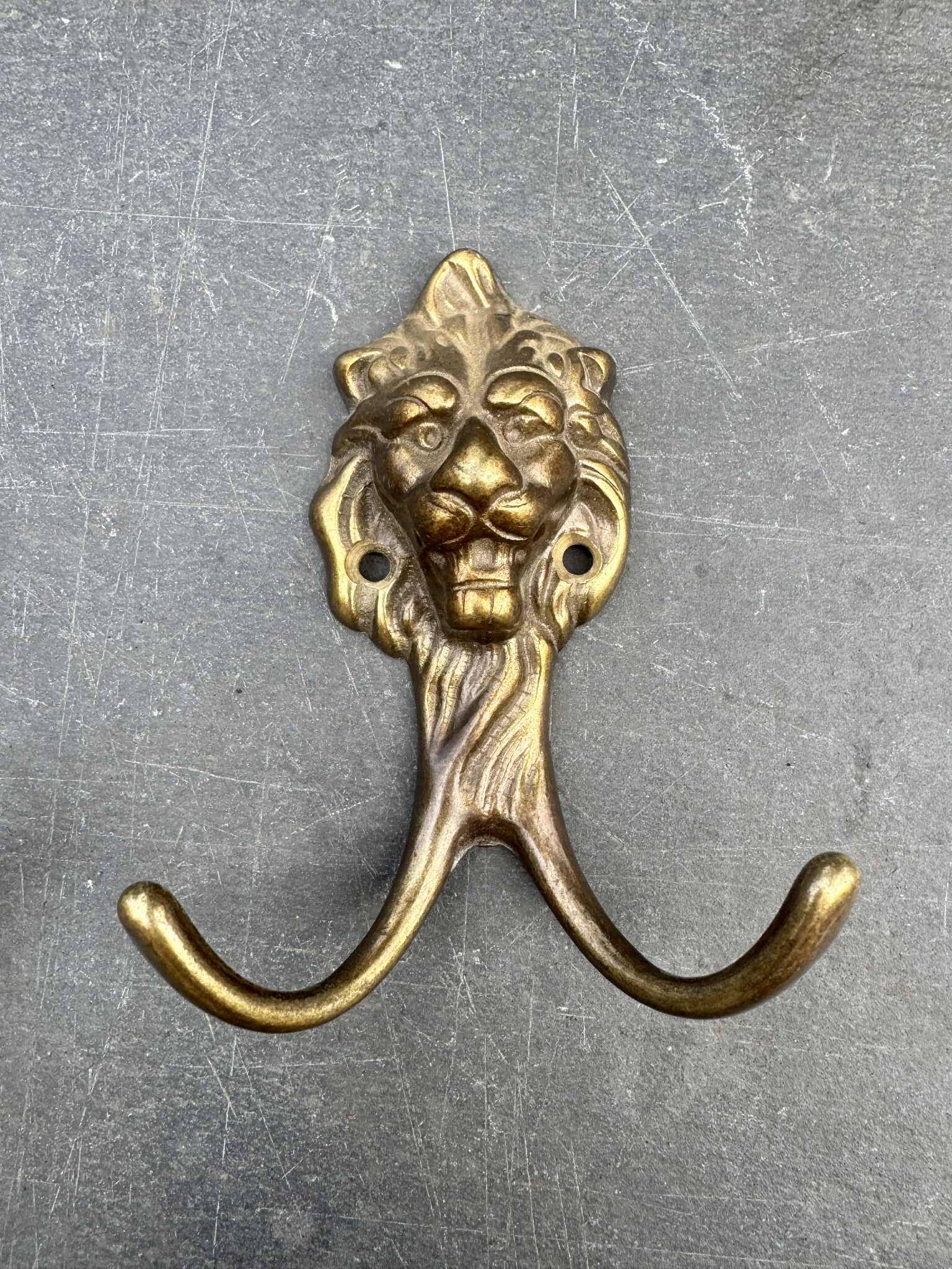 Antique brass lion coat hook