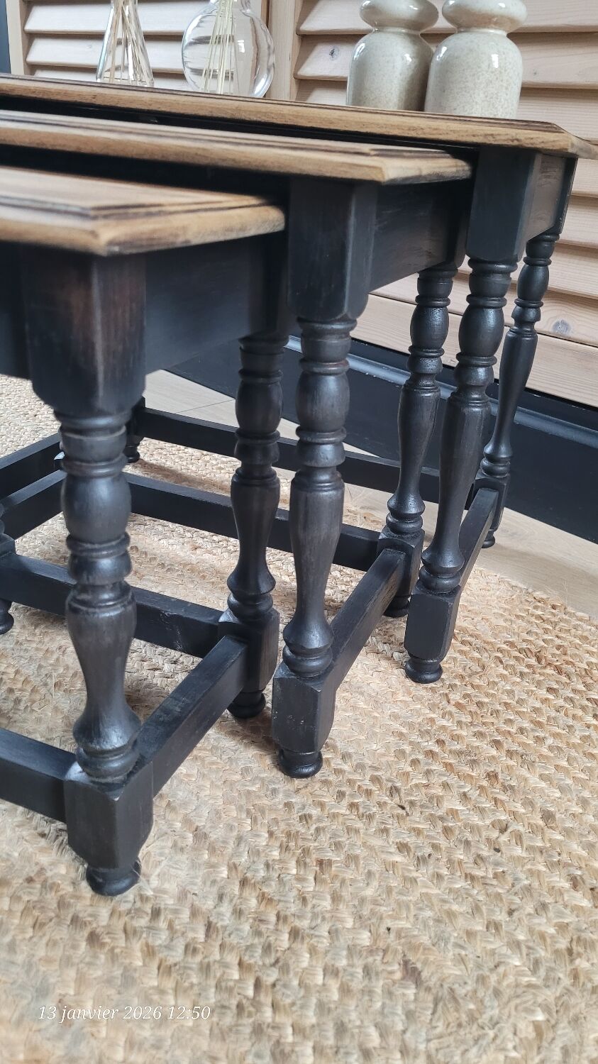 Nest tables in wood and black.