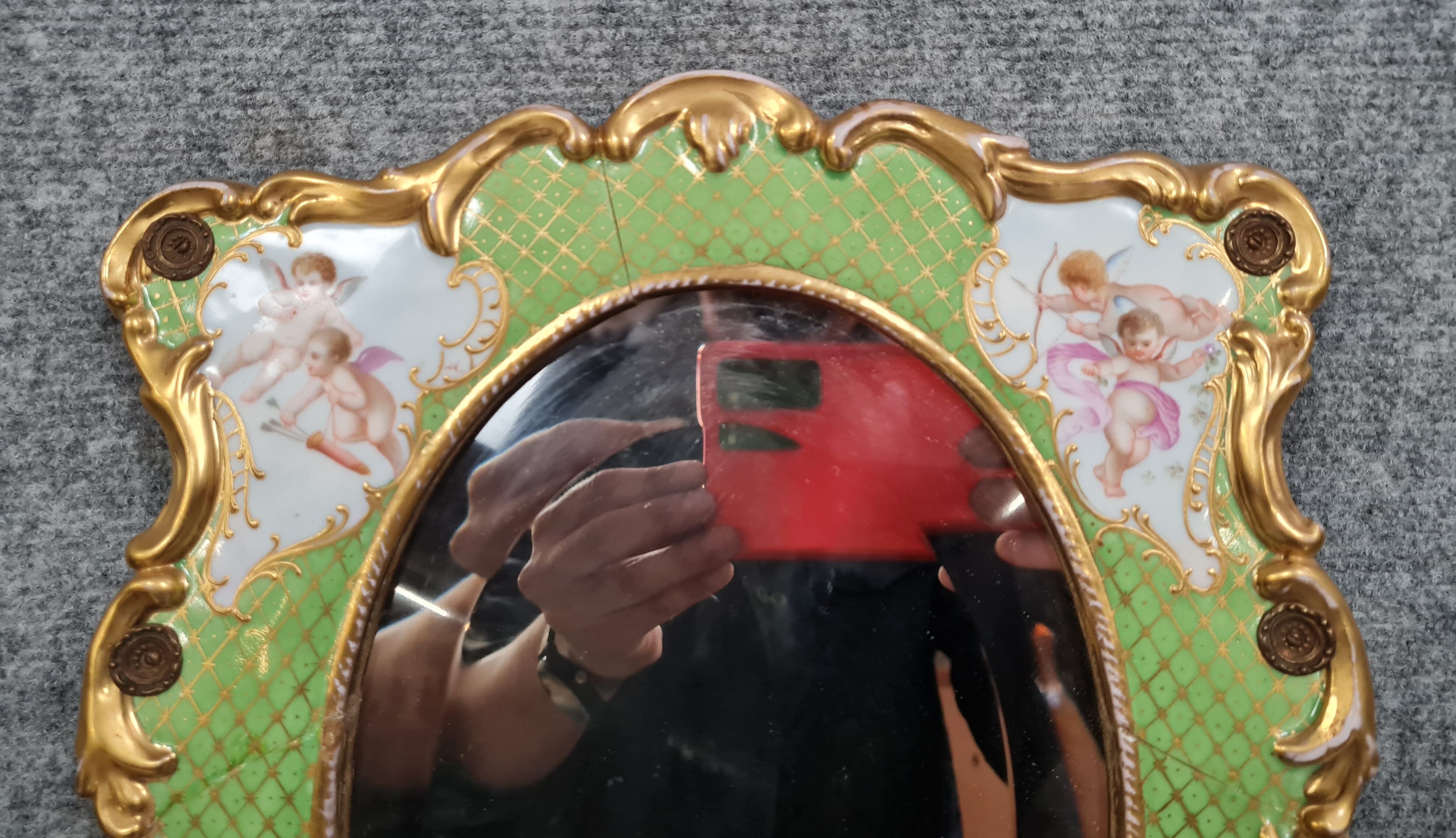 Porcelain mirror with cherub decorations circa 1900