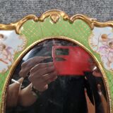 Porcelain mirror with cherub decorations circa 1900