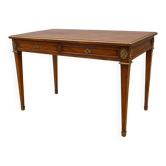Louis XVI style flat desk in mahogany, resting on four tapered legs.