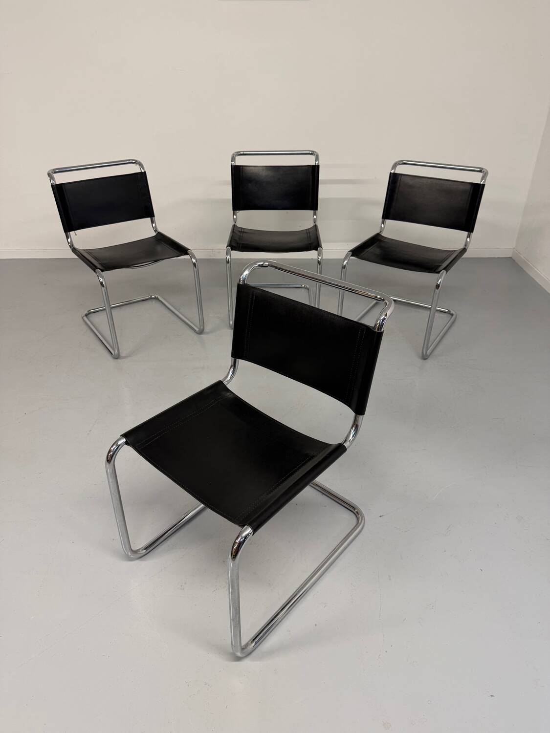 Lot of 4 tubular chairs designed by Mart Stam in vintage black leather from the 1980s.