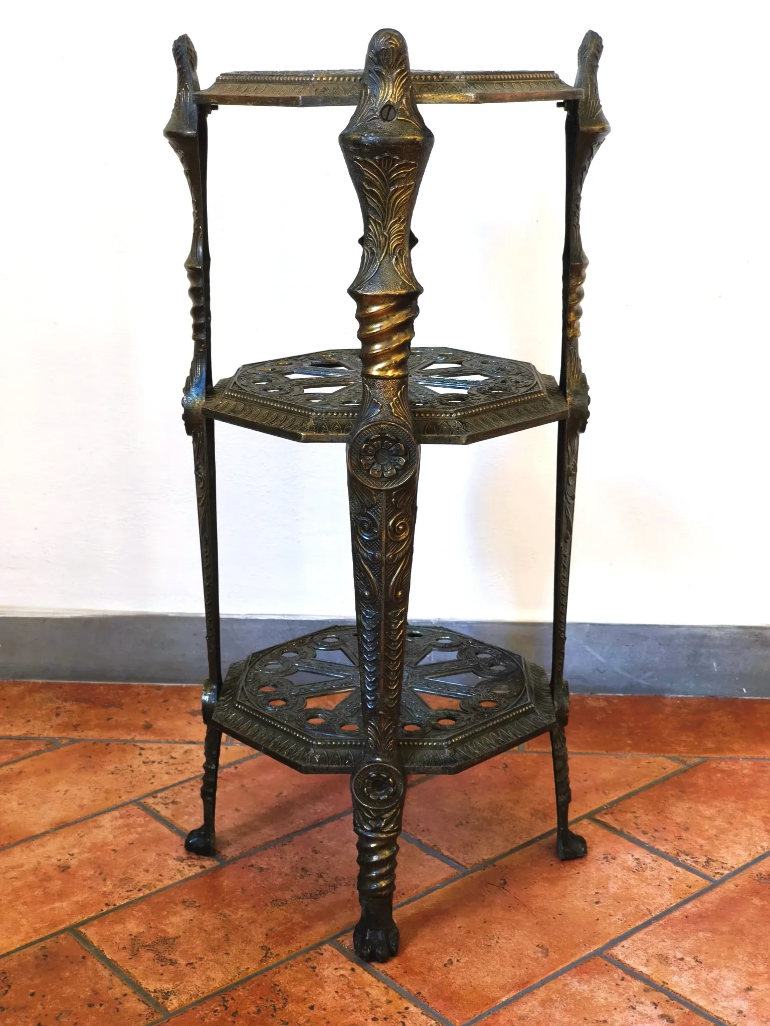 Italian side table with three openwork shelves in patinated metal.