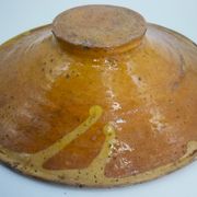 Old omelette turner, glazed yellow terracotta, south of France.