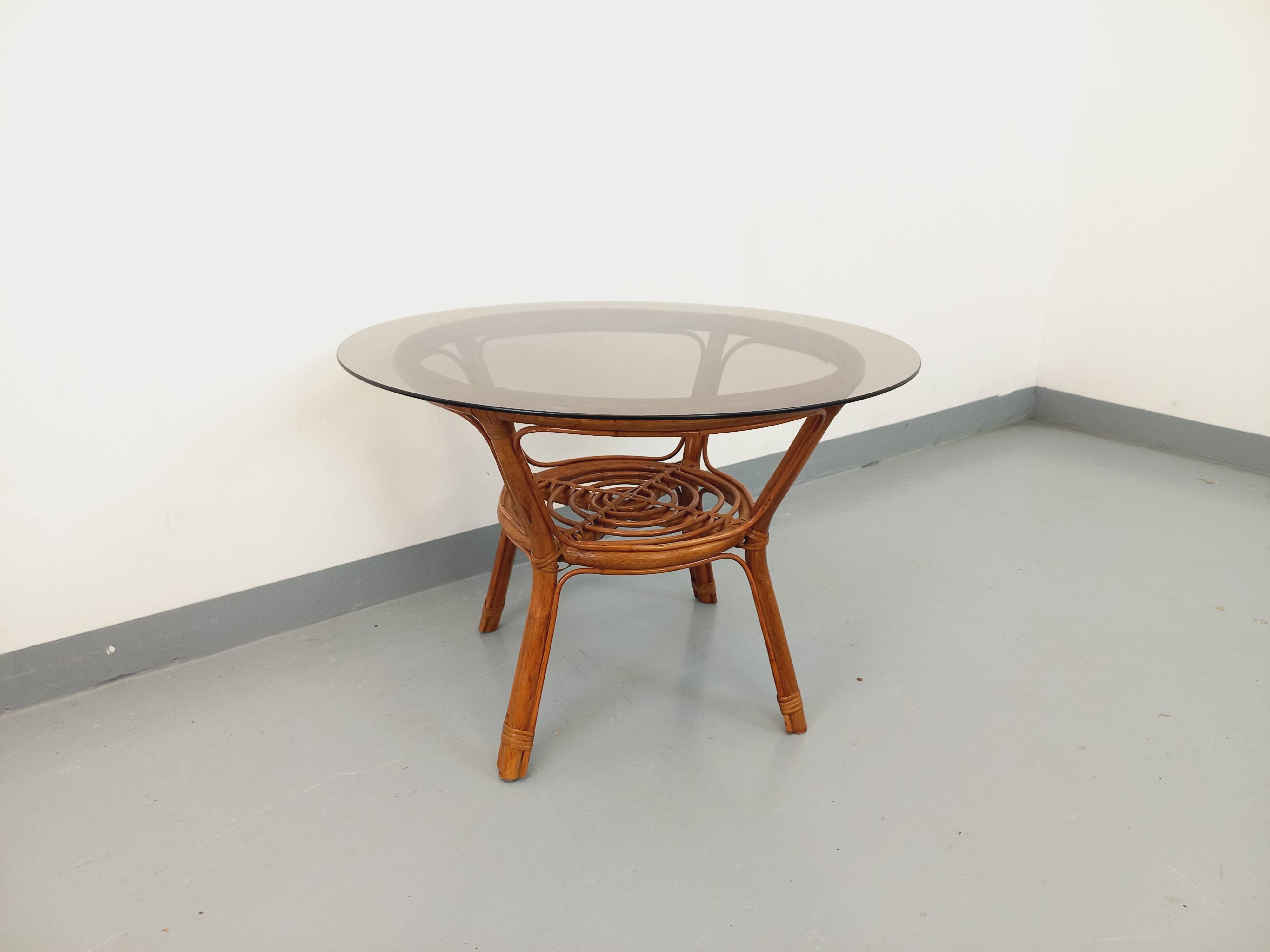 Vintage round smoked glass and rattan coffee table from the 70s