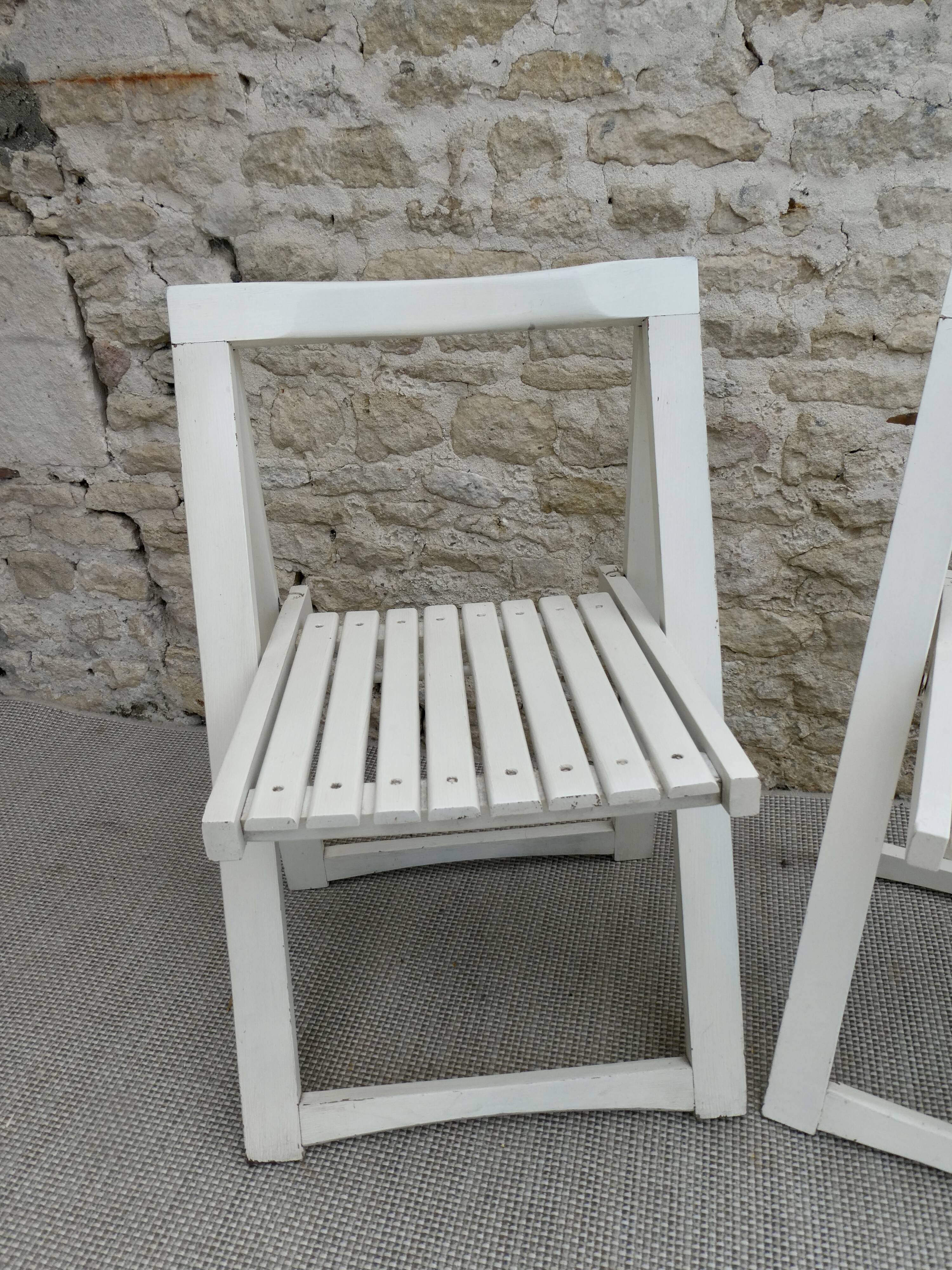 Pair of folding wooden chairs, white patina, circa 1960.