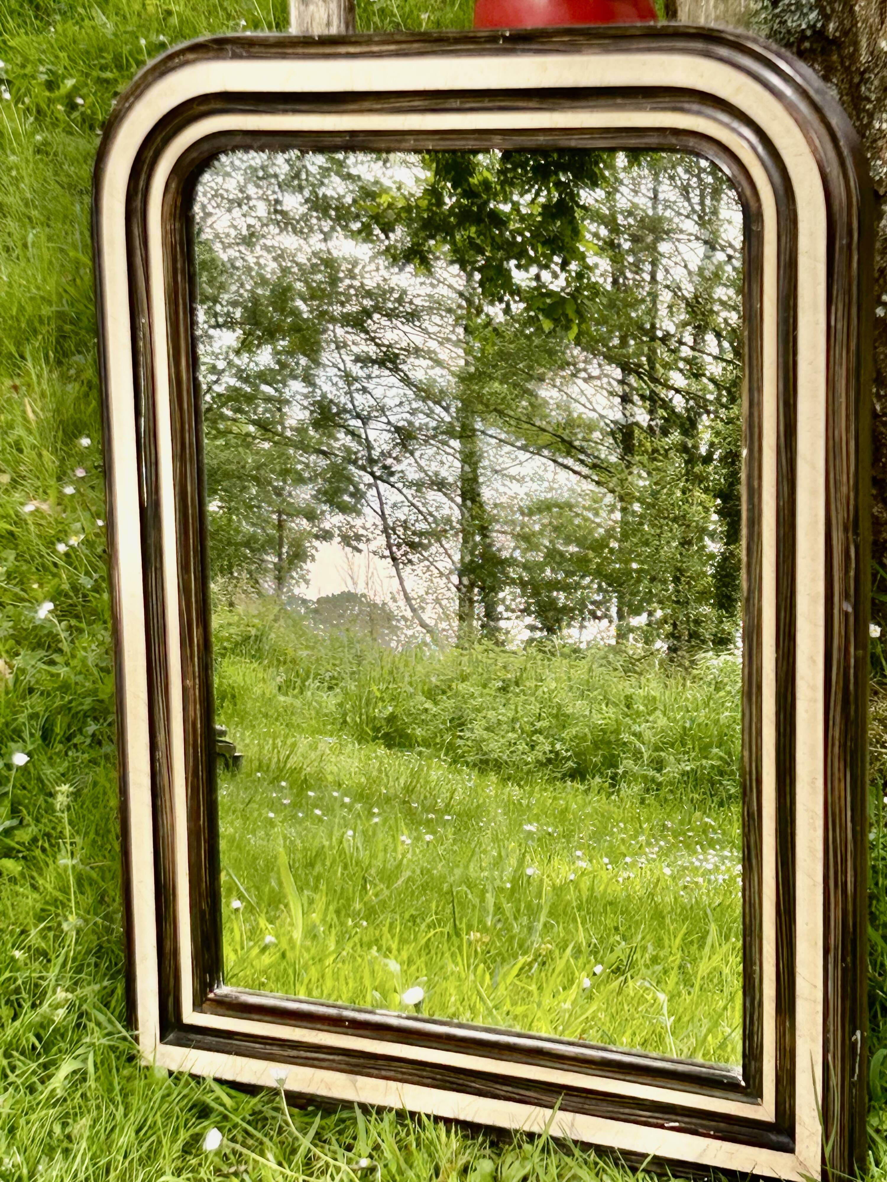 Louis Philippe mirror, wood and stucco with faux wood decoration. 19th century. 56 x 74.