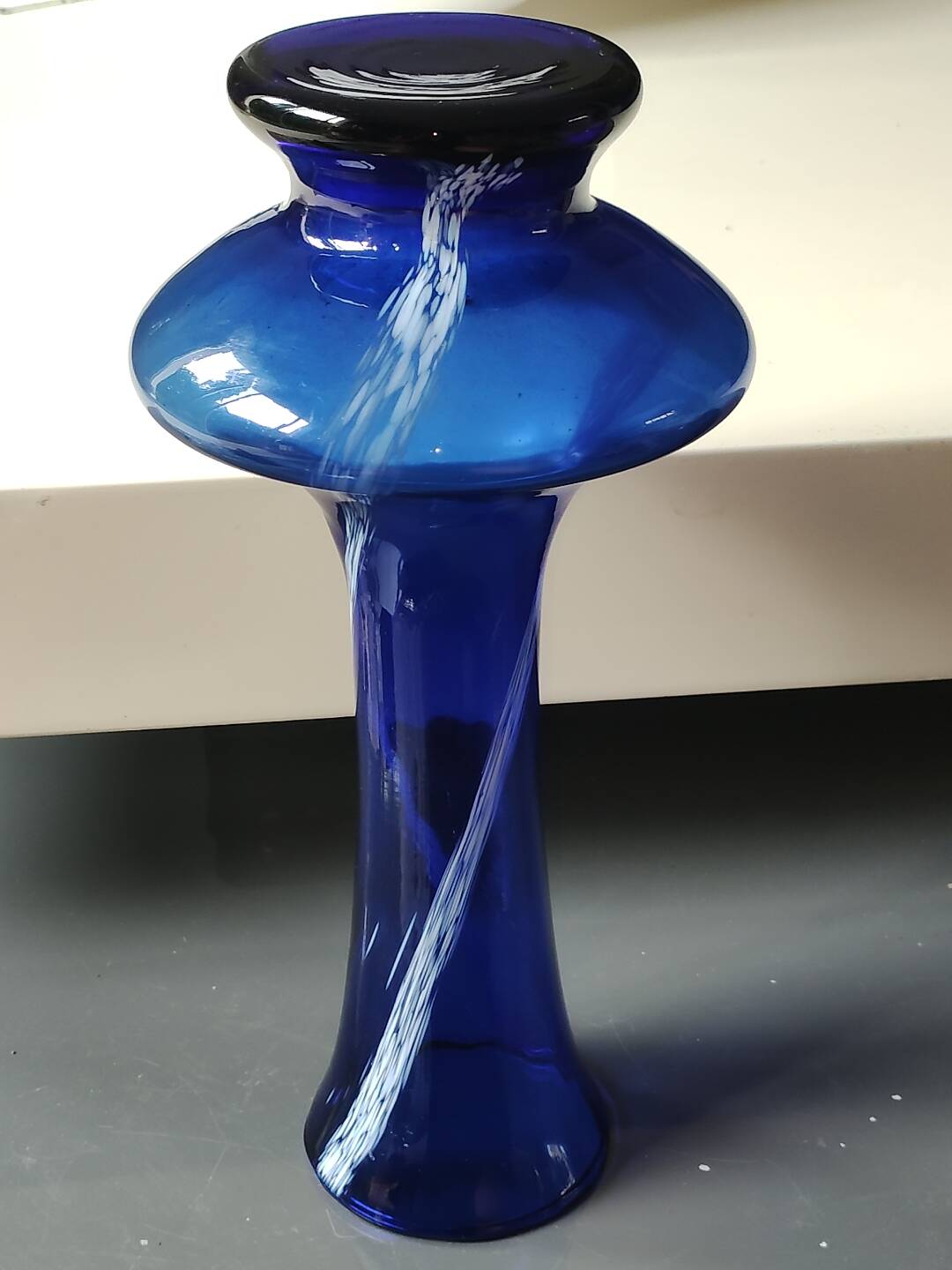 Long flared neck ball vase. Smoked scrolls in cobalt blue art glass, 30cm