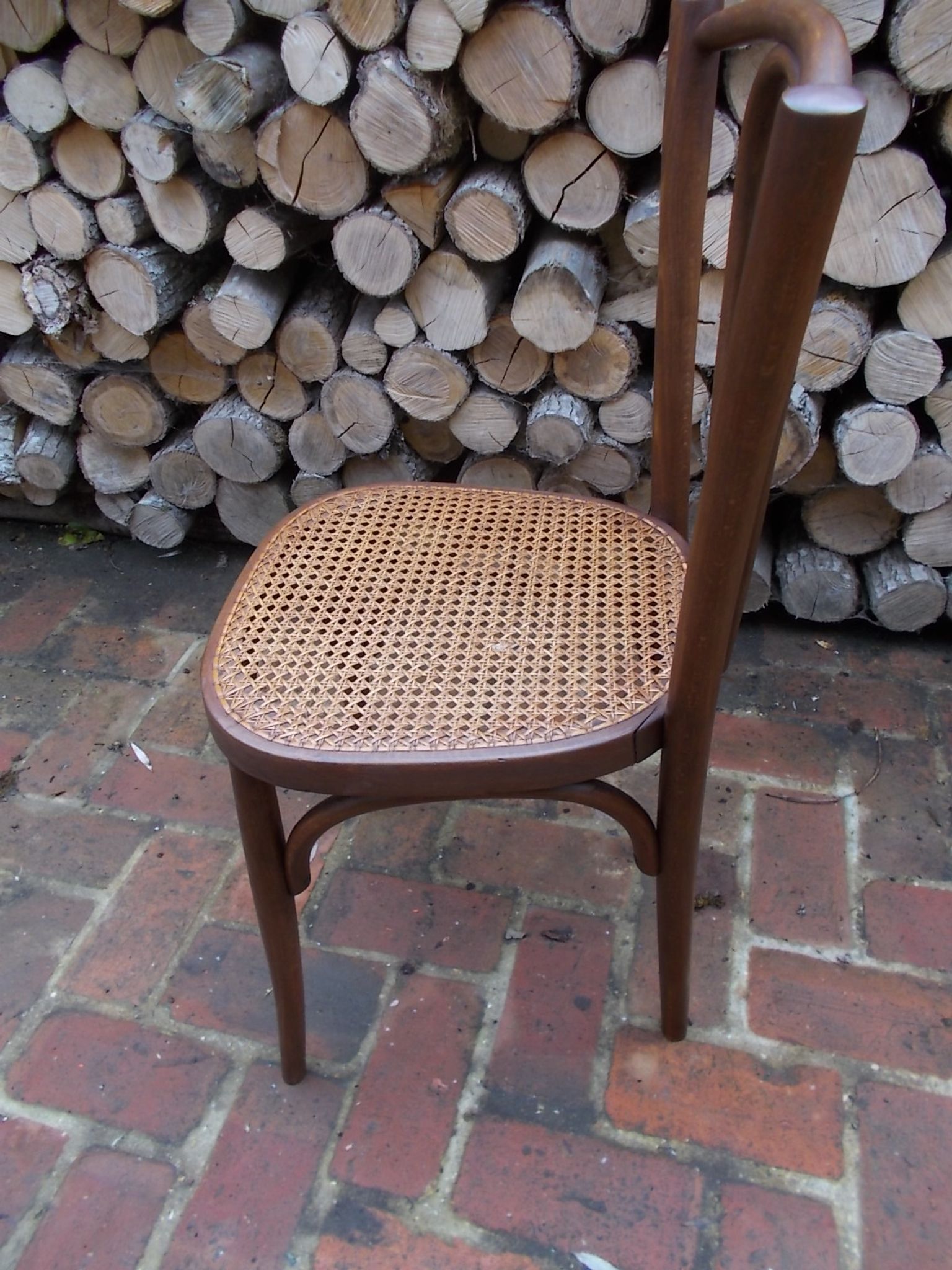 Curved wooden bistro chair with caning