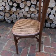 Curved wooden bistro chair with caning