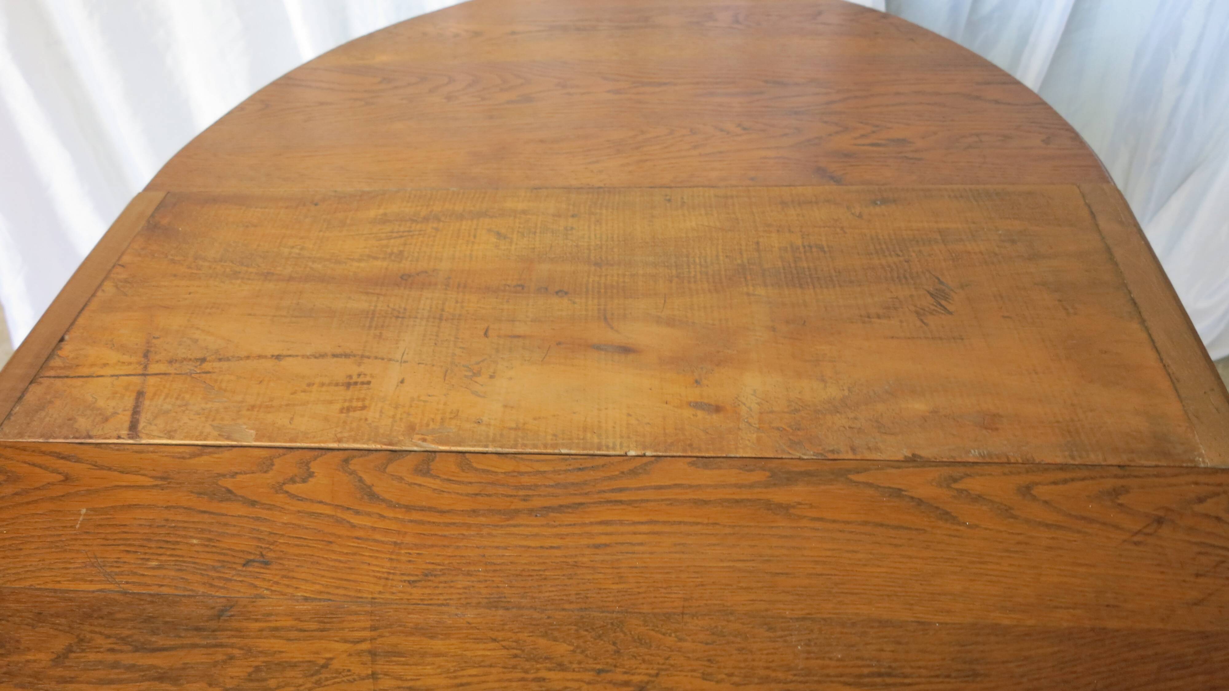 1930s oak dining table, slightly oval.