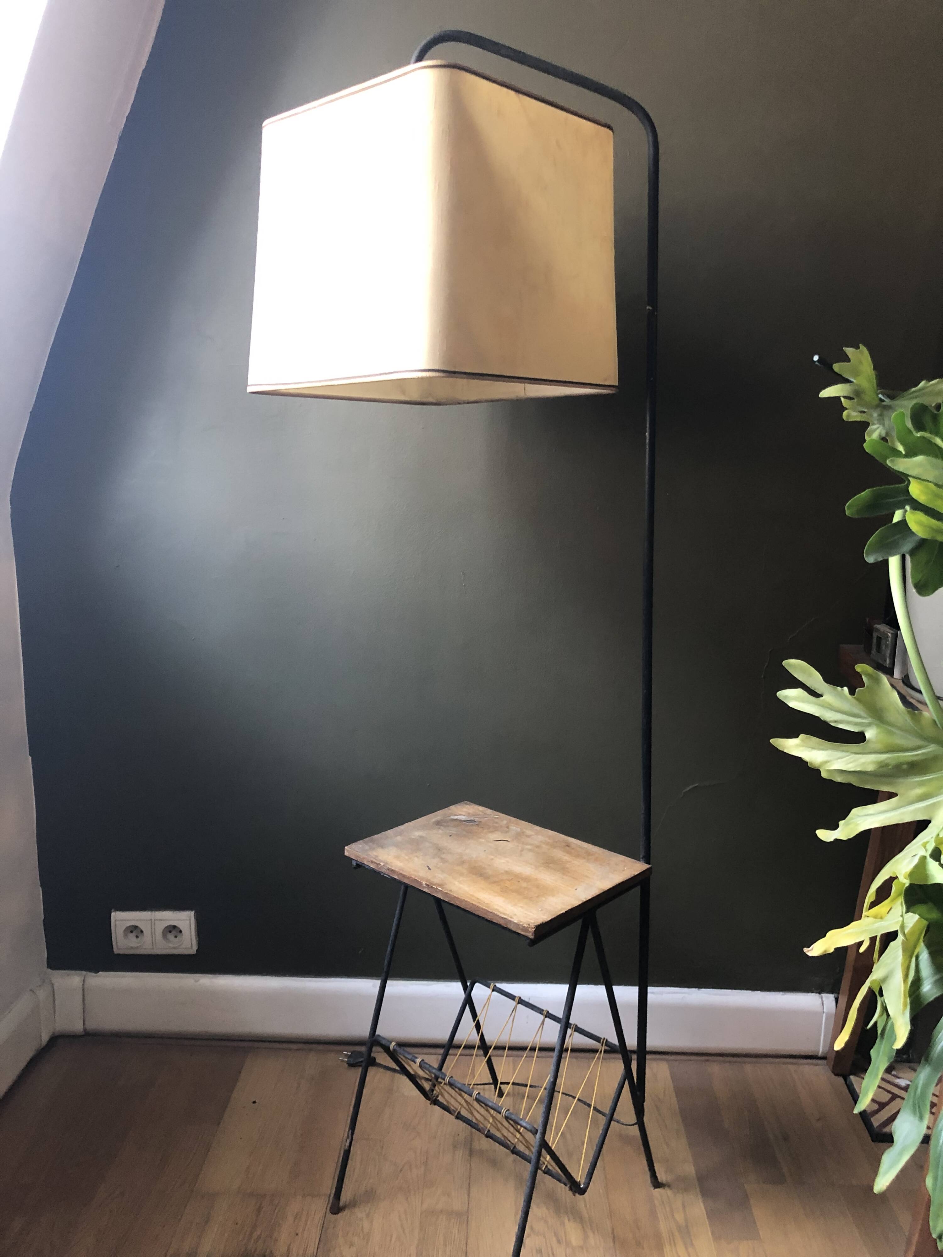 Modernist floor lamp with shelf and magazine holder.