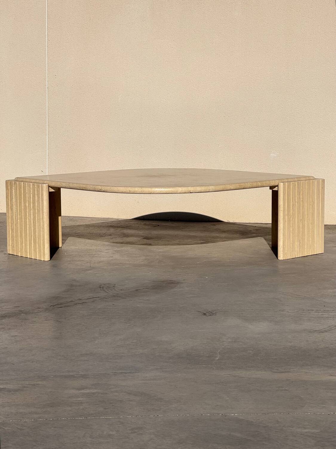 Large designer coffee table in travertine, eye shape, Roche Bobois edition from the 80s