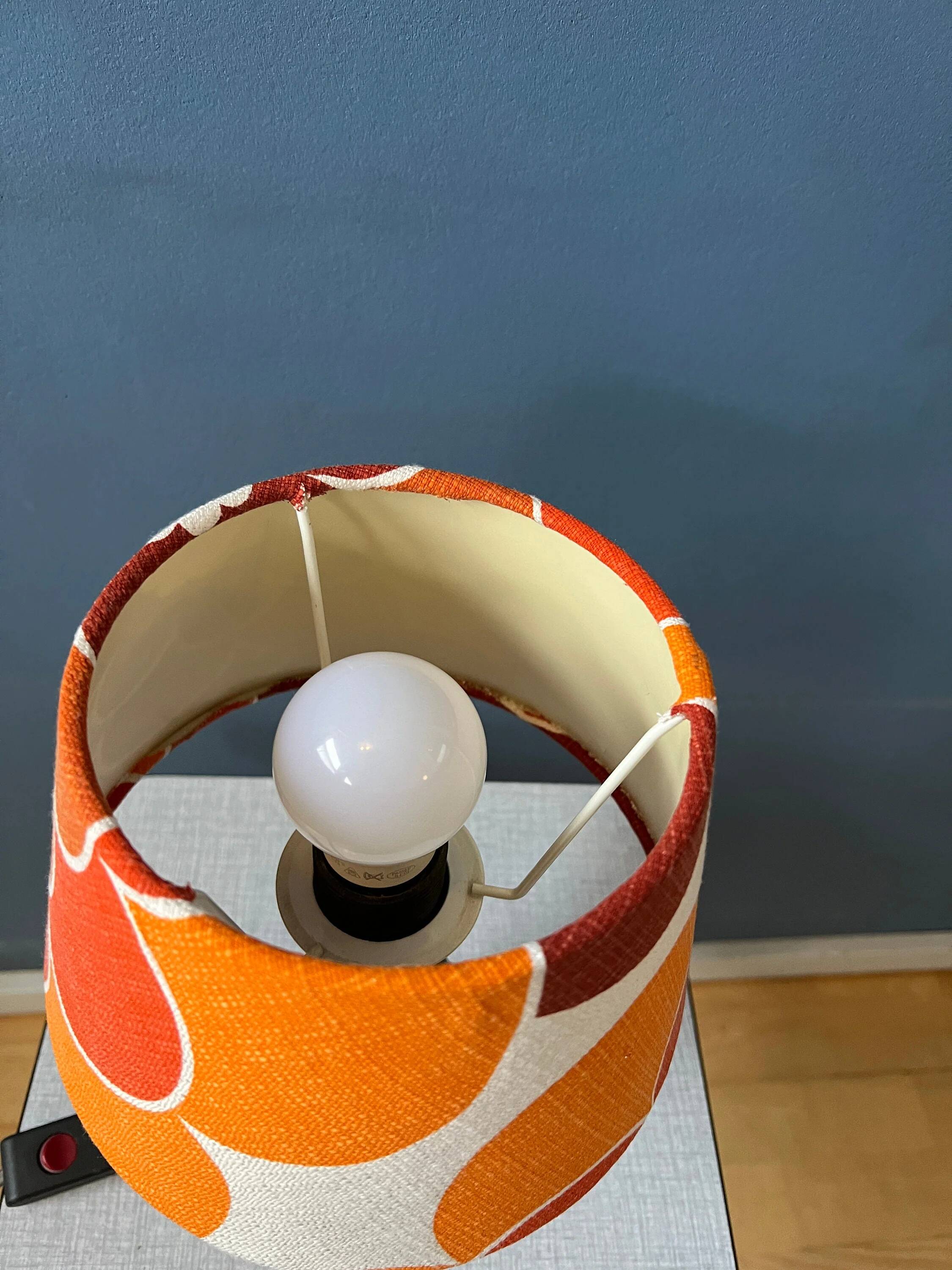 Vintage Space Age table lamp with orange fabric shade.