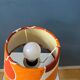 Vintage Space Age table lamp with orange fabric shade.