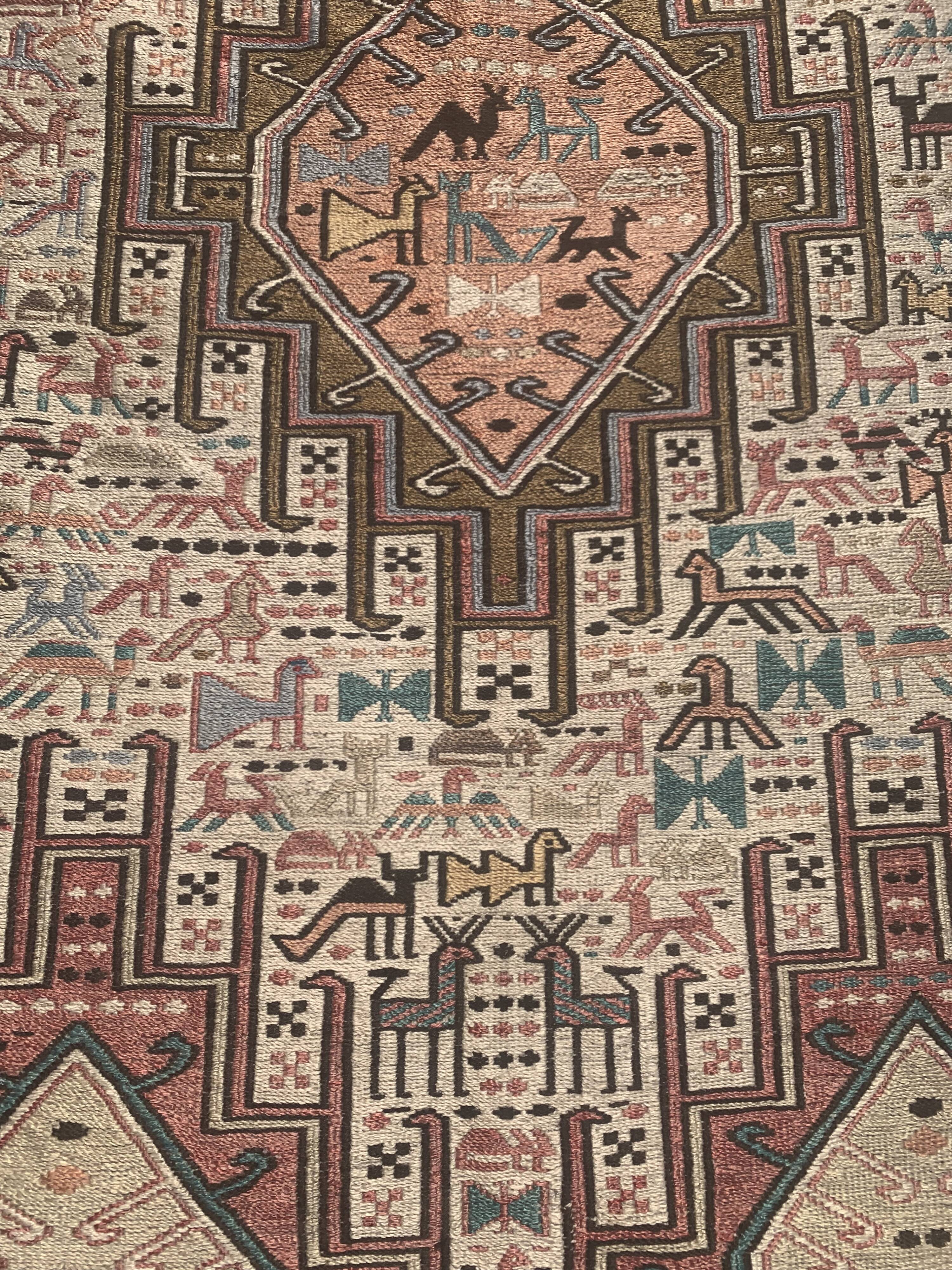 Hand-knotted silk carpet purchased in Iran – geometric and animal design –